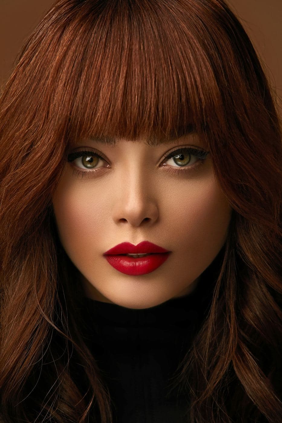 Editorial stock: glossy copper color with soft waves and bangs. Not client work.